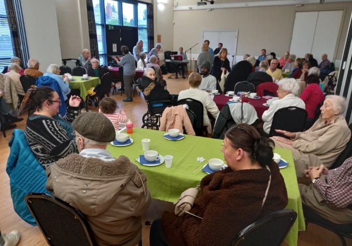 Leeds Jewish Welfare Board | Your Community Centre Community event with people sat round tables in community hall